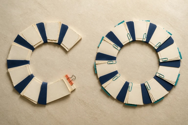 Two circular manuscript arrangements: one interrupted by a coral clip, the other complete with source attachments.